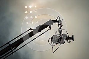TV camera on a crane on football mach or concert photo