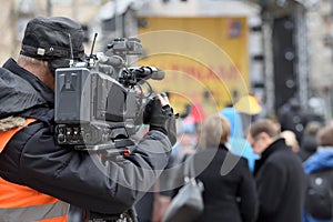 TV camera man filming event