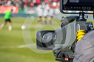 TV camera at the stadium, broadcasting during a football, soccer match