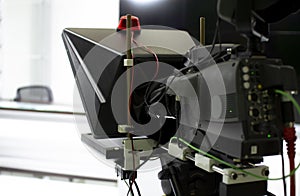 TV camera in the Studio. Teleprompter and professional high-definition video camera on a tripod.