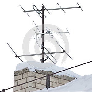 TV and communication aerials on snowy roof of residential house, multiple isolated dvb-t antennas winter scene, large detailed