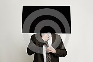 TV headed businessman standing on white background. Brainwash and manipulation concept photo