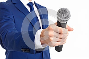 TV host holding microphone, white background