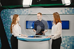 Tv host and two participants on game show