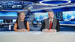 TV Live News Program: Two Diverse Professional Presenters Reporting On the Events. Television Cable