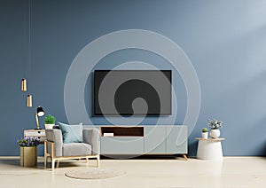 TV in modern living room with armchair have empty dark blue wall background