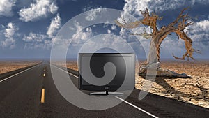 TV monitor on desert road