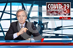 TV News screen with male anchorman reporting latest news on the novel pandemic coronavirus Covid-19
