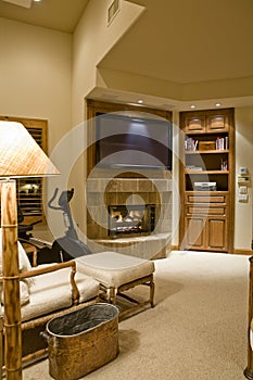 TV Over Fireplace With Reclining Chair In Foreground