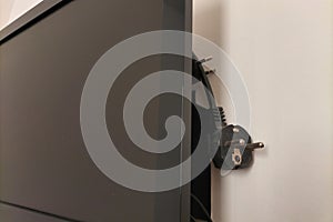 TV plug is unplugged from outlet. Symbol of protection against knowingly false information, news that is poured by photo