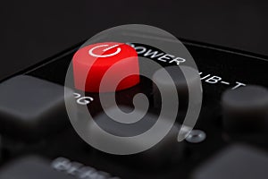 TV power button on the remote control on black background