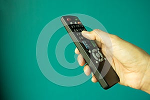 TV remote control in female hand