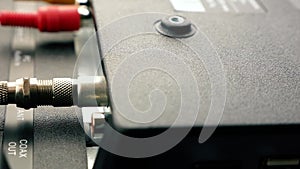 TV repair and tuning theme. Close-up view of an antenna cable plugged into a TV socket. Restoration of television broadcasting. Ac