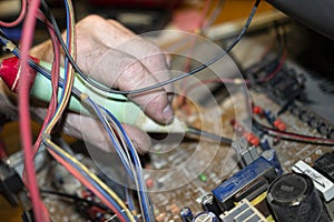 TV repairing at home engineer are testing electronic components