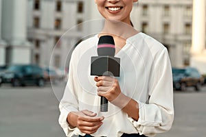 TV reporter presenting the news outdoors. Journalism industry, live streaming concept.