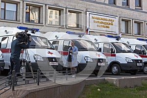 TV reporters shoot reportage on the transfer of cars first aid clinics Vologda and Cherepovets near the government building of the