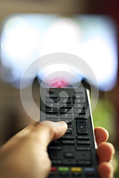 TV remote control device on hand photo