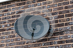 TV satellite dish on a brick wall