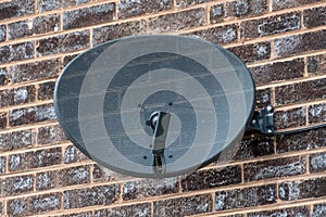 TV satellite dish on a brick wall