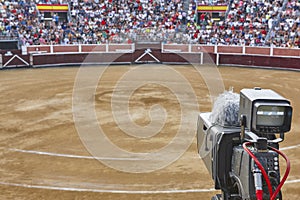 Tv set on a bullring filled with people. Bullfighting