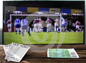 On the TV there is a league of champions on football on a table bookmaker`s tickets and euro, rates on sports