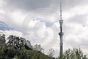 TV tower against the background of a cloudy sky. Koktobe Television and radio broadcast tower in Almaty, Kazakhstan.