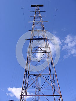 TV tower on blue sky background with satellite antennas and radio signals