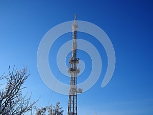 TV tower and cell tower in the fog. Misty winter morning