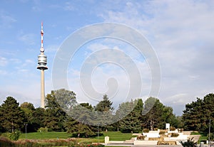 Tv tower Donauturm and fountain in Donau Park Vienna photo