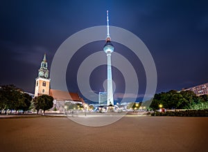 TV Tower (Fernsehturm) and St. Mary Church at night - Berlin, Germany