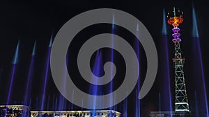 TV Tower in festival illumination. On foreground fountain with long exposure water drop. Festive concept