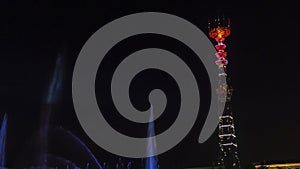 TV Tower in festival illumination. On foreground fountain with long exposure water drop. Festive concept.