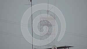 TV tower and roofs of houses during the hurricane wind and rain.