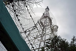 TV tower with telephone transmitters against a cloudy sky
