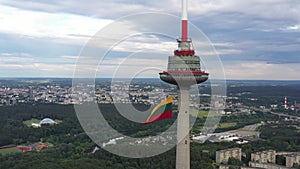 TV Tower in Vilnius, Lithuania and The Largest Waving Lithuanian Flag  in Background. Statehood Day in Lithuania