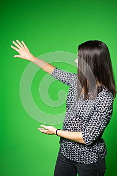 TV weather news reporter at work.News anchor presenting the world weather report.Television presenter recording in a green screen