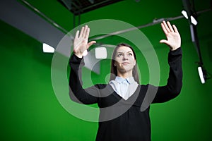 TV weather news reporter at work.News anchor presenting the world weather report.Television presenter recording in a green screen