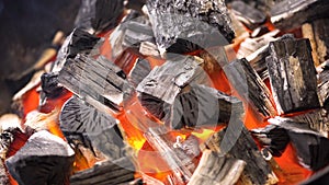 TView Of Hot Flaming Charcoal Briquettes Glowing In The BBQ Grill Pit. Burning Coals For Cooking Barbecue Food. Close Up