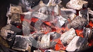 TView Of Hot Flaming Charcoal Briquettes Glowing In The BBQ Grill Pit. Burning Coals For Cooking Barbecue Food. Close Up