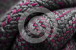 Tweed fabric weave macro texture with herringbone pattern, gray background with cranberry color flecks