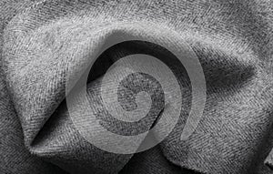 Tweed fabric, wool gray herringbone textile background.