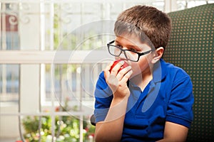 Tween biting an apple