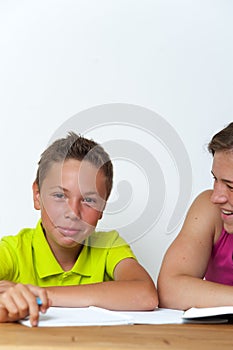 Tween boy doing homework lessons with his mother