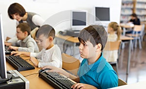 Tween boy during lesson in computer room