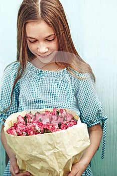 Tween girl holding bunch of roses