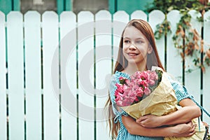 Tween girl holding bunch of roses