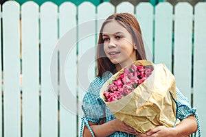 Tween girl holding bunch of roses