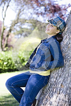 Tween Girl leaning on Tree