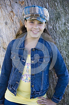 Tween Girl leaning on Tree