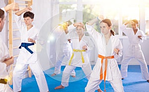 Tween girl practicing punches during group martial arts workout